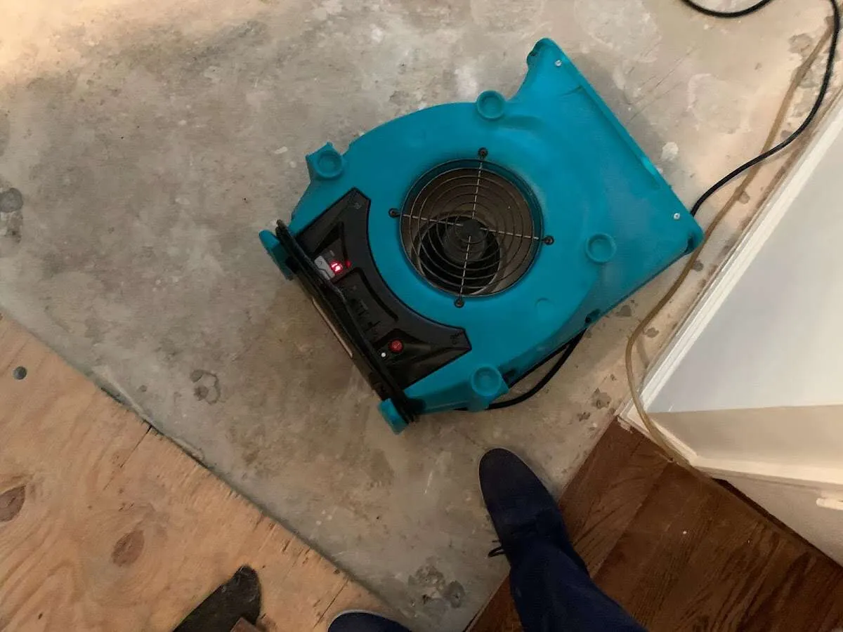 Air mover drying subfloor during Leak Detection & Repair in Blaine